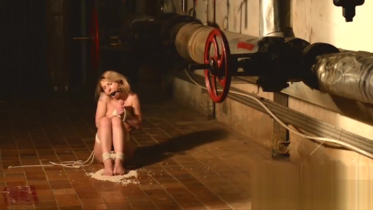 Kate in the cellar tiptoeing and kneeling on beans
