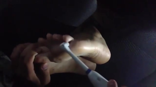 Guy tickles his girlfriends feet in car
