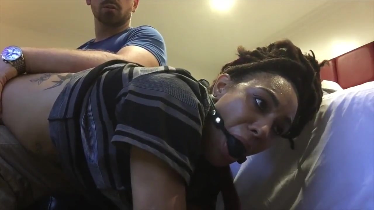 Black girl has wrists zip-tied, and is ballgagged before OTK spanking.
