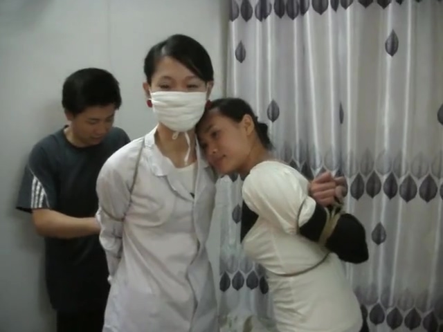 Two Chinese Girls Tied, One Wearing Cloth Mask
