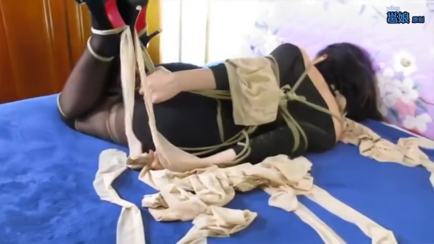 Young Asian Woman Tied & Gagged On The Bed
