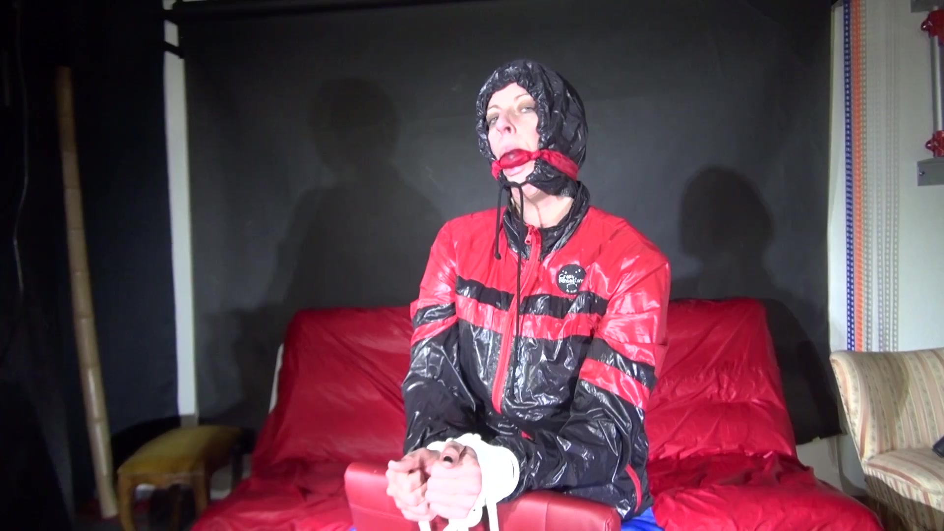 Sexy Pia Being Tied And Gagged On A Chair Wearing Sexy Shiny Nylon Rainwear (Video)
